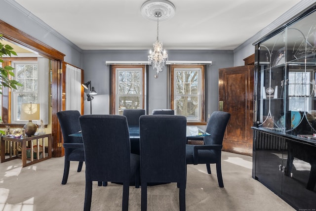 dining area featuring crown molding, plenty of natural light, light carpet, and a notable chandelier