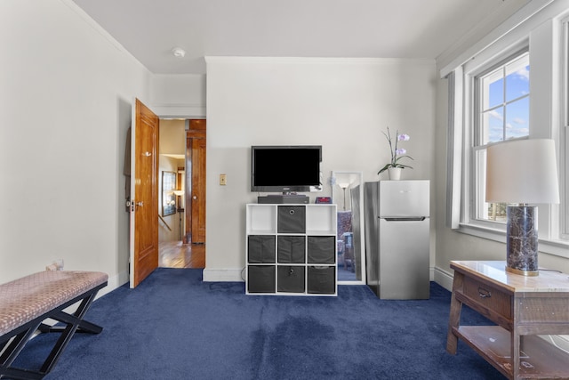 bedroom with dark carpet, ornamental molding, and freestanding refrigerator