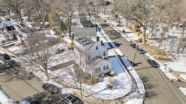 snowy aerial view featuring a residential view