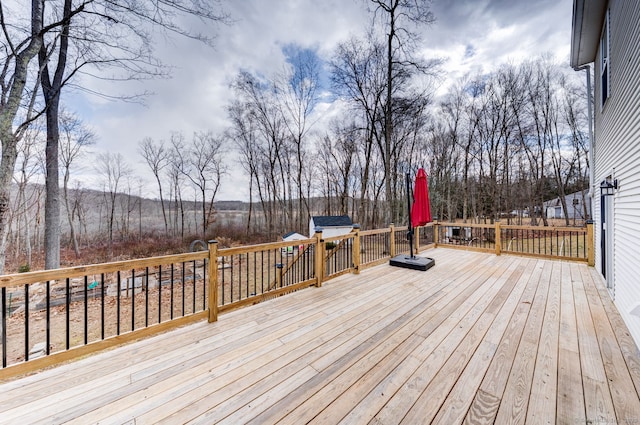 wooden terrace featuring an outdoor structure