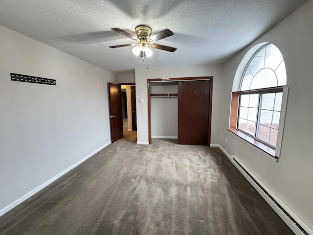 unfurnished bedroom with a textured ceiling, a baseboard radiator, carpet floors, baseboards, and a closet