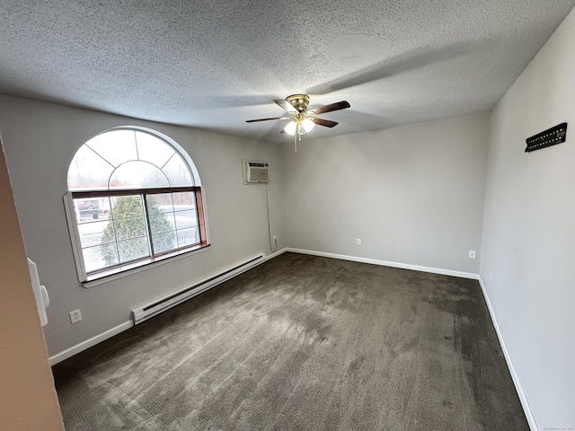 spare room featuring baseboard heating, dark carpet, a ceiling fan, and baseboards