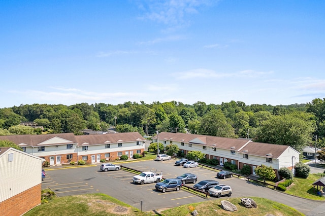 bird's eye view featuring a forest view and a residential view