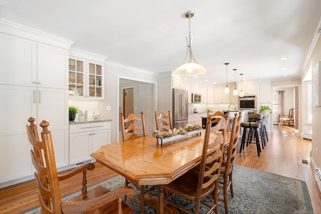 dining area with recessed lighting, a baseboard radiator, visible vents, ornamental molding, and light wood-type flooring