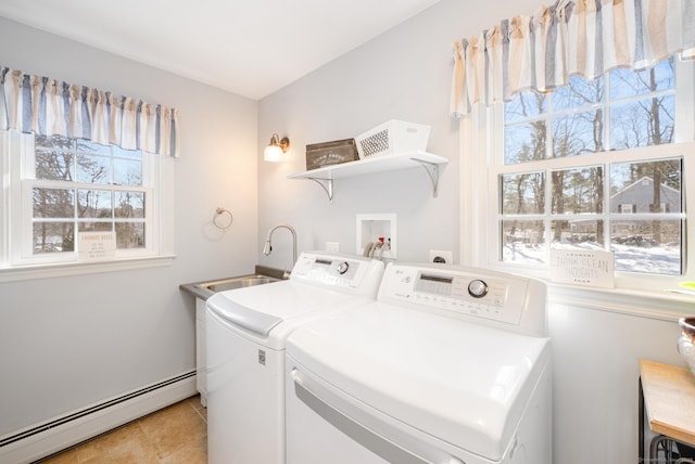 laundry area featuring a baseboard radiator, laundry area, independent washer and dryer, and a sink