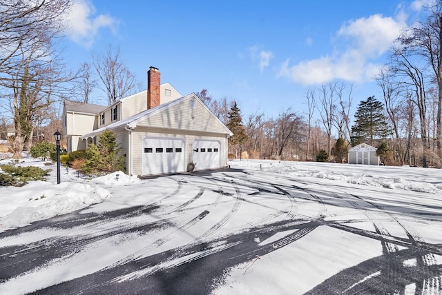 snow covered property with a chimney