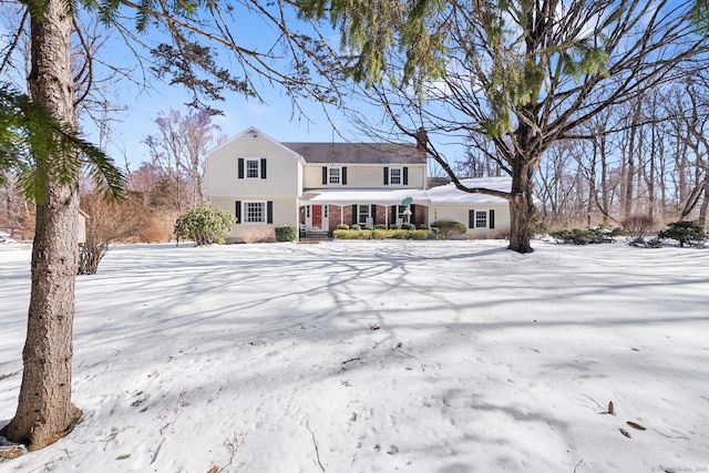 view of front of house featuring covered porch and brick siding