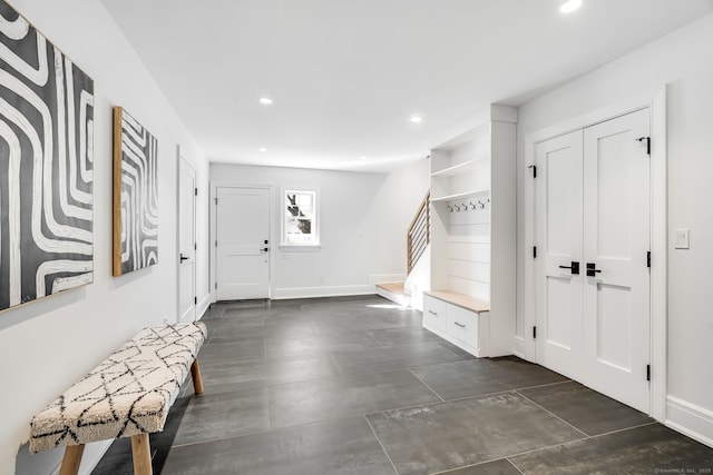 foyer entrance featuring stairs, baseboards, and recessed lighting