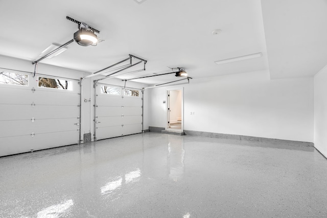 garage with a garage door opener and baseboards