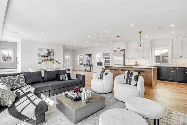 living area featuring light wood finished floors and recessed lighting