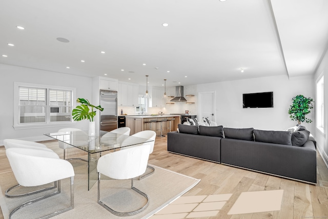 dining area featuring light wood-type flooring, a wealth of natural light, and recessed lighting