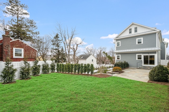 exterior space featuring a patio, a yard, entry steps, and fence