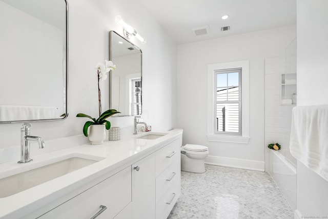 full bath with toilet, double vanity, visible vents, and a sink