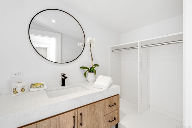 bathroom with recessed lighting and vanity