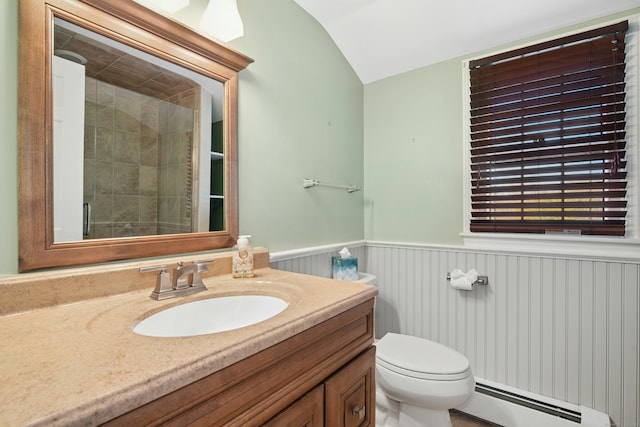 bathroom with a wainscoted wall, lofted ceiling, toilet, baseboard heating, and vanity