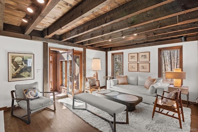 living area with wood ceiling, wood finished floors, beam ceiling, and baseboards