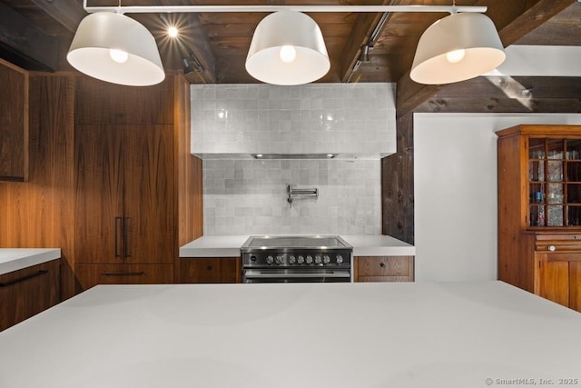 kitchen featuring brown cabinets, tasteful backsplash, light countertops, electric range, and modern cabinets