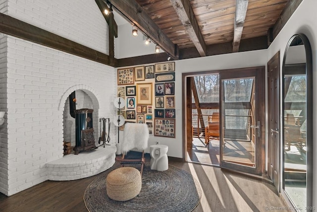 sitting room with brick wall, wood finished floors, wood ceiling, beamed ceiling, and track lighting