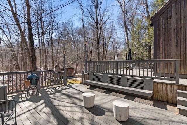 wooden terrace featuring a grill