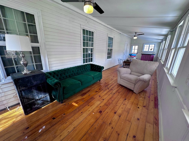 sunroom with vaulted ceiling and a ceiling fan