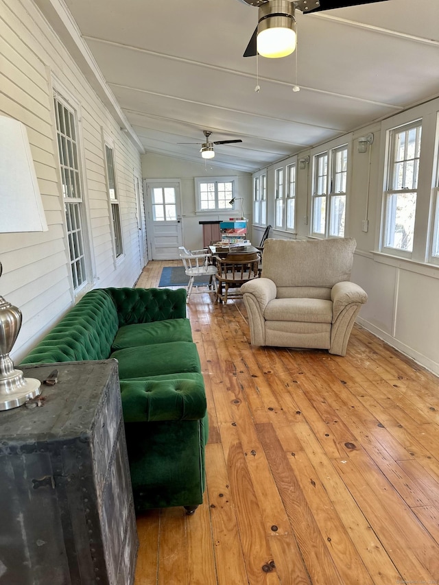 sunroom / solarium with a ceiling fan and a healthy amount of sunlight