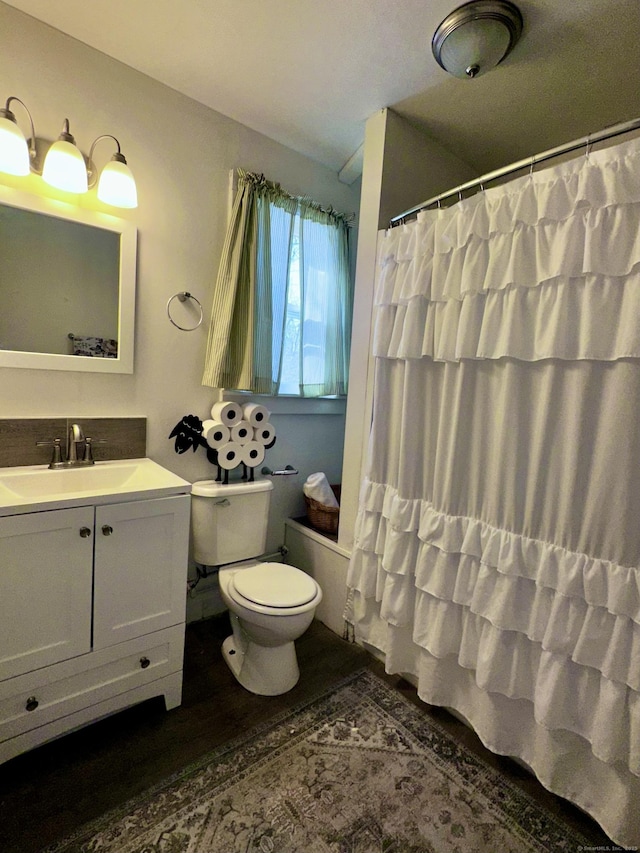 full bath featuring toilet, wood finished floors, shower / bath combination with curtain, and vanity