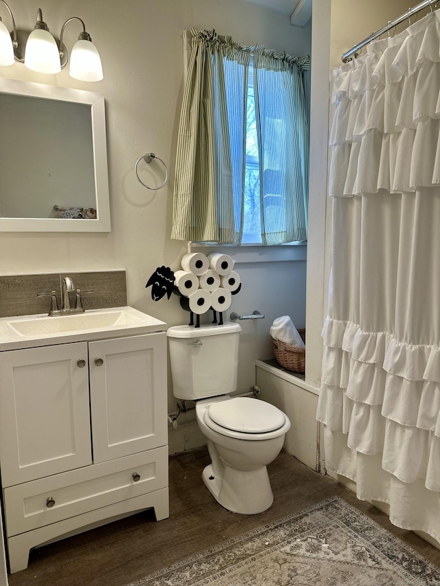 bathroom featuring a shower with curtain, vanity, toilet, and wood finished floors