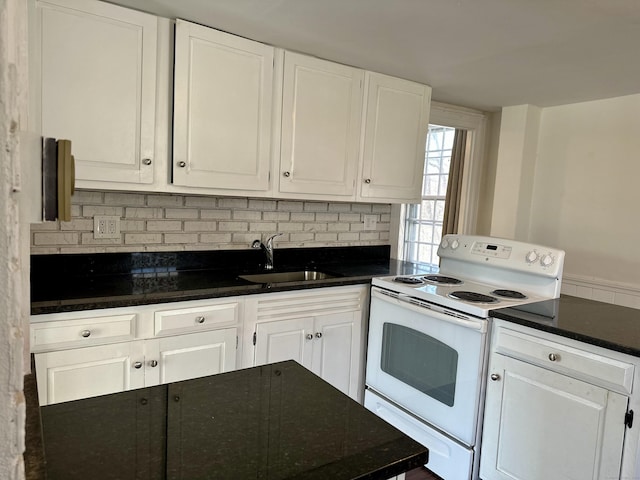 kitchen with tasteful backsplash, white range with electric stovetop, white cabinets, and a sink