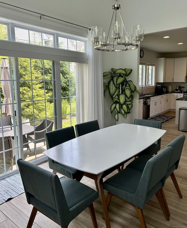 dining area with light wood-style floors and recessed lighting