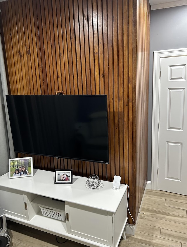 interior space with built in study area, wood walls, and light wood finished floors