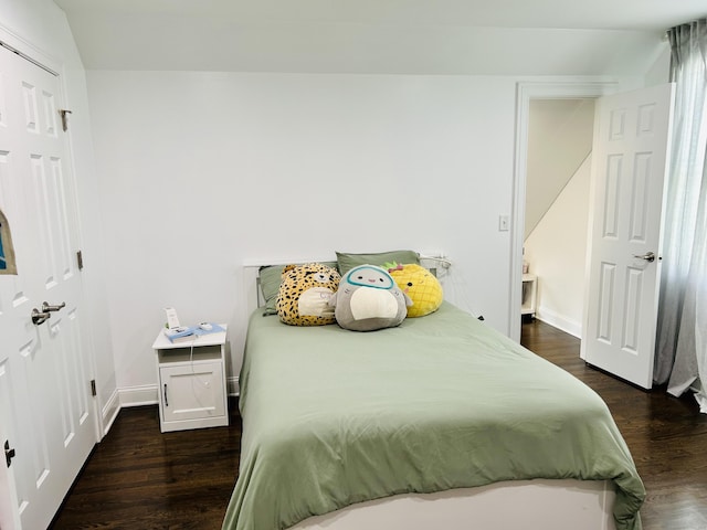 bedroom featuring dark wood finished floors and baseboards