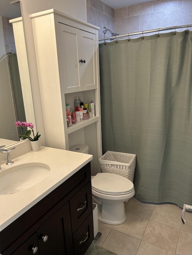 full bathroom with tile patterned flooring, vanity, and toilet