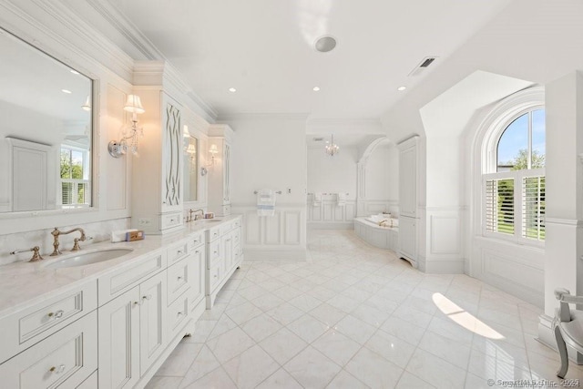 bathroom with double vanity, a wealth of natural light, visible vents, and a sink