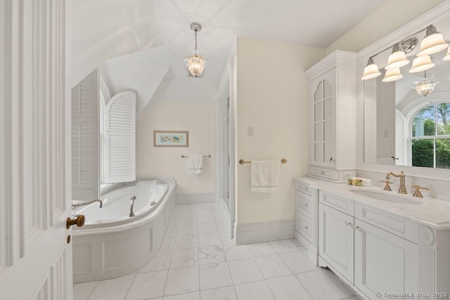 full bath with a notable chandelier, vanity, baseboards, marble finish floor, and a bath