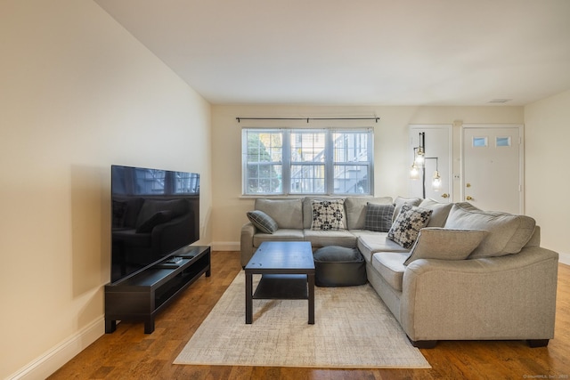 living room featuring wood finished floors and baseboards