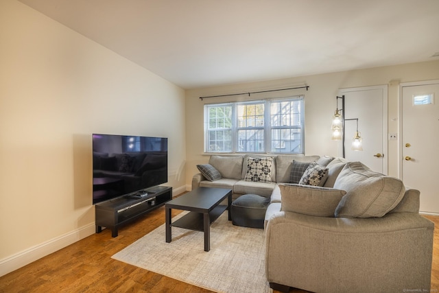 living area with wood finished floors and baseboards