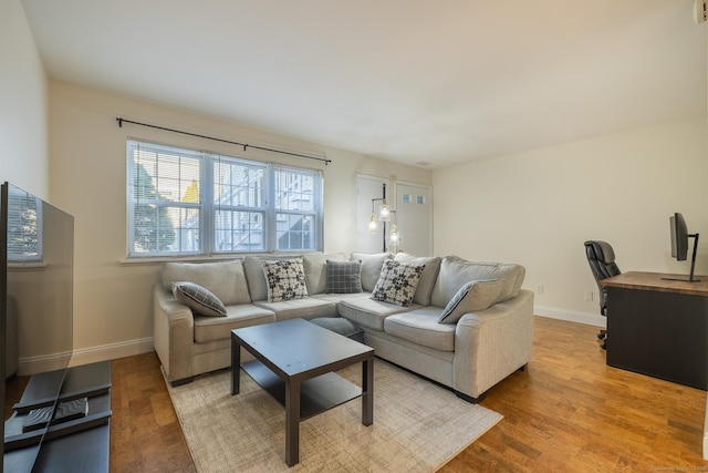 living room with wood finished floors and baseboards