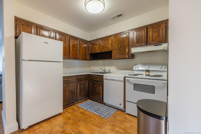 kitchen featuring visible vents, white appliances, light countertops, and under cabinet range hood