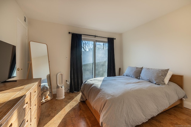 bedroom with baseboards and access to exterior