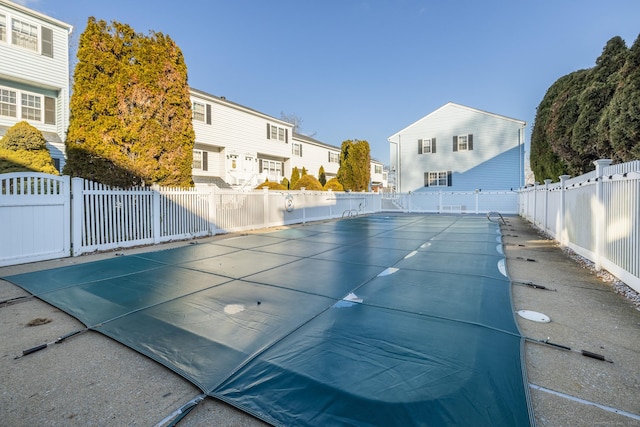 view of pool with a residential view, fence, and a fenced in pool