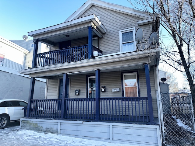 view of front of house featuring a balcony and a porch