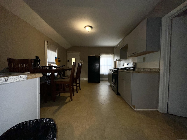 kitchen featuring gas range and freestanding refrigerator