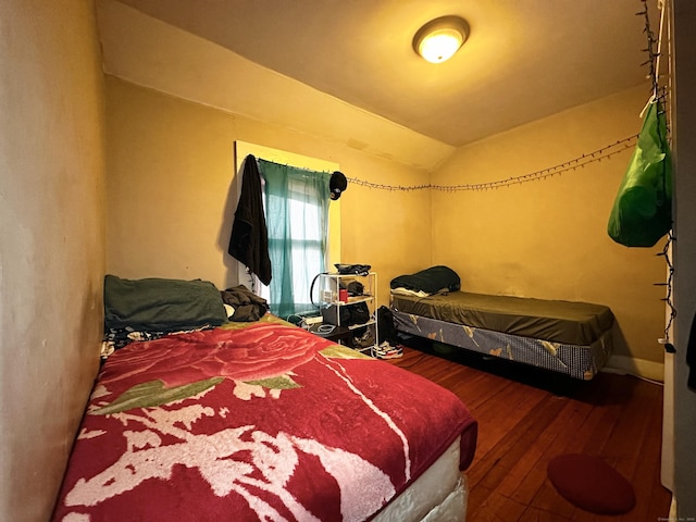 bedroom featuring vaulted ceiling and hardwood / wood-style floors