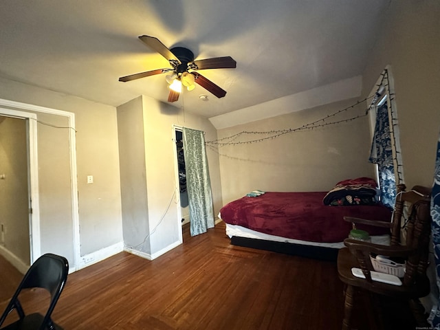 bedroom with baseboards, a ceiling fan, vaulted ceiling, and wood finished floors