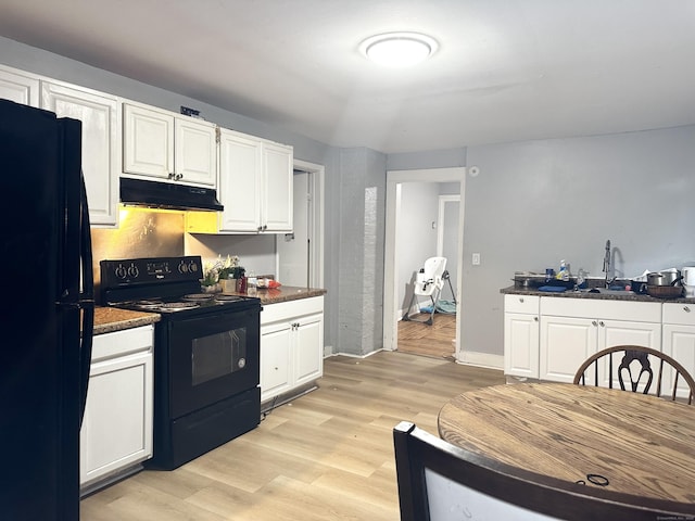 kitchen featuring black appliances, dark countertops, and under cabinet range hood