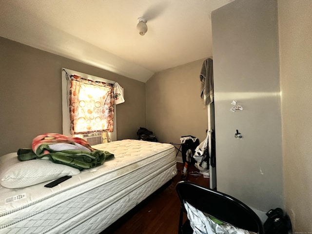 bedroom with dark wood-style floors and lofted ceiling