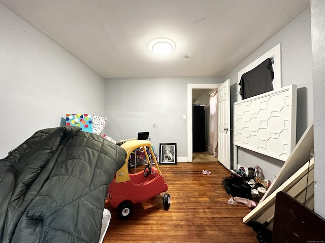 bedroom featuring baseboards and wood finished floors