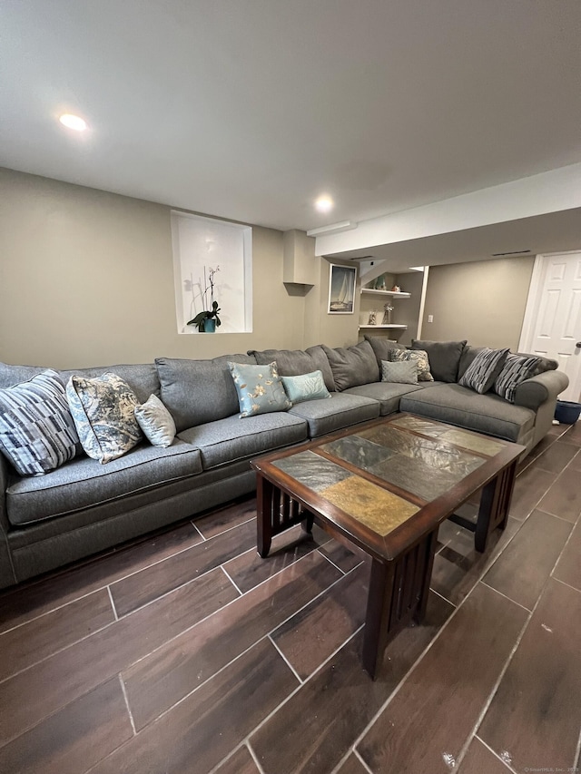 living area with wood tiled floor and recessed lighting