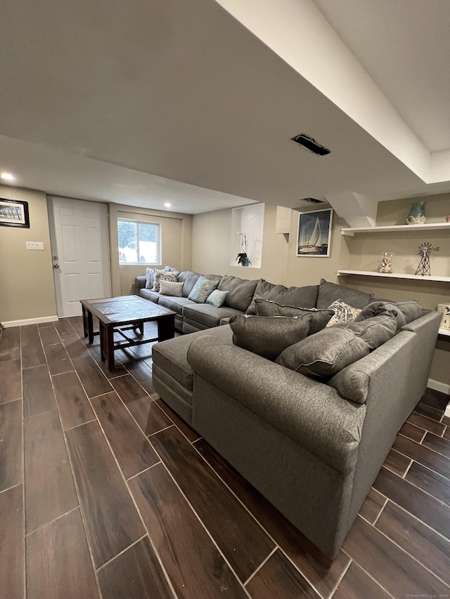 living room with wood finish floors, baseboards, and recessed lighting