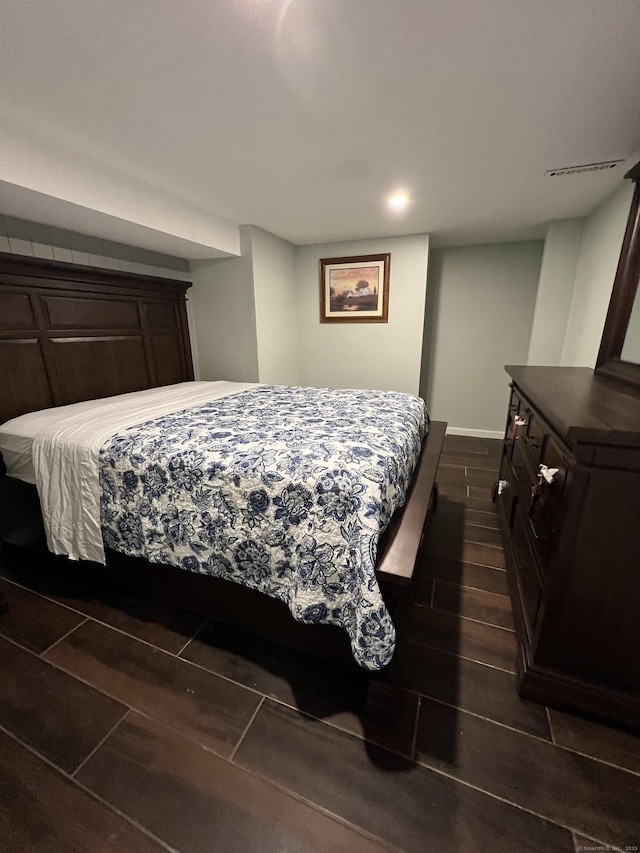 bedroom with wood finish floors and baseboards